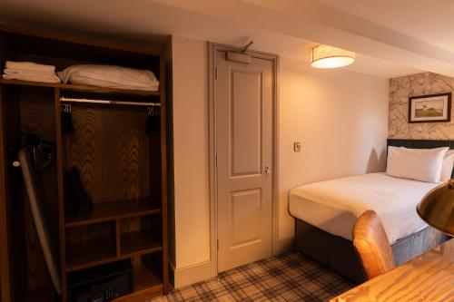 a small room with a bed and a closet at Offshore - The Inn Collection Group in Lytham St Annes