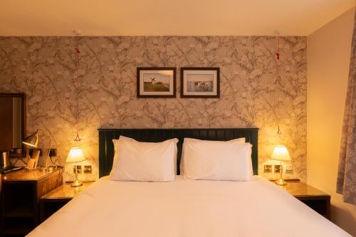 a bedroom with a large bed with two lamps at Offshore - The Inn Collection Group in Lytham St Annes