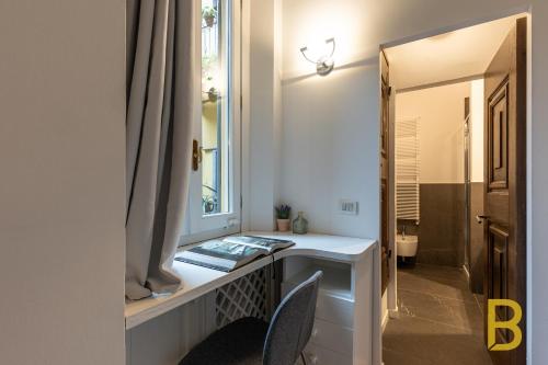 La salle de bains est pourvue d'une coiffeuse et d'un miroir. dans l'établissement BePlace Apartments in Magenta, à Milan