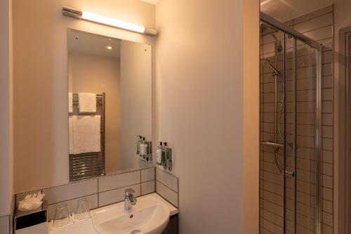 a bathroom with a sink and a mirror at Offshore - The Inn Collection Group in Lytham St Annes