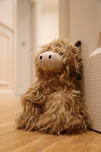 a stuffed teddy bear sitting on the floor at Yarm Luxury Apartments - Bank House - private gated carpark in Yarm