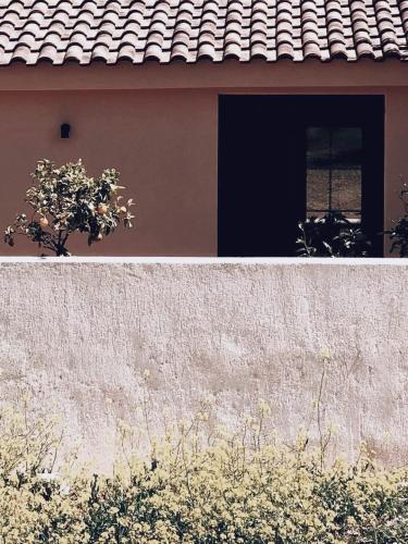 a house with a wall and a window at ALFIEA HOME 65m2 & ALFIEA STUDIO 35m2 in Artemida