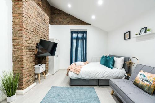 a living room with a bed and a couch at Central-comfyStudio-quite in London