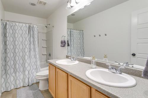 a bathroom with two sinks and a toilet at Spacious Denver Vacation Home about 18 Mi to Downtown! in Aurora