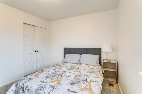 a bedroom with a bed and a white wall at Spacious Denver Vacation Home about 18 Mi to Downtown! in Aurora