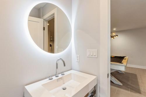 a bathroom with a white sink and a mirror at Villa Kimaal - Luxury with pool in Sag Harbor