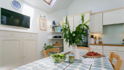 a kitchen with a table with a vase on it at Moryn in Moelfre