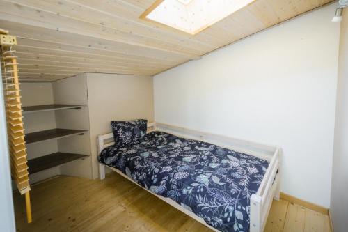um pequeno quarto com uma cama e uma clarabóia em Maisonnette Cosy à Proximité de la Gare em Valence