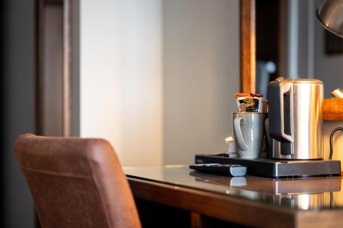 a desk with a coffee maker and a cup on it at Offshore - The Inn Collection Group in Lytham St Annes