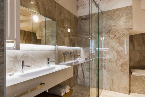 a bathroom with a sink and a shower at Villa Santa Maria Maddalena by Palazzo di Varignana in Casalecchio deʼ Conti