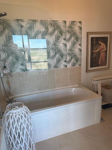 a bath tub in a bathroom with a window at 湖景度假屋Lakeview Vacation Home in Belturbet