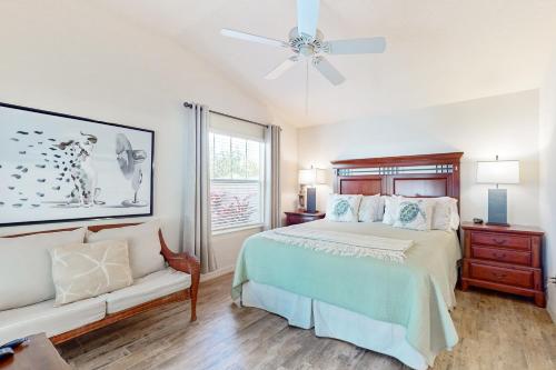a bedroom with a bed and a ceiling fan at Southern Sun Villa in The Villages