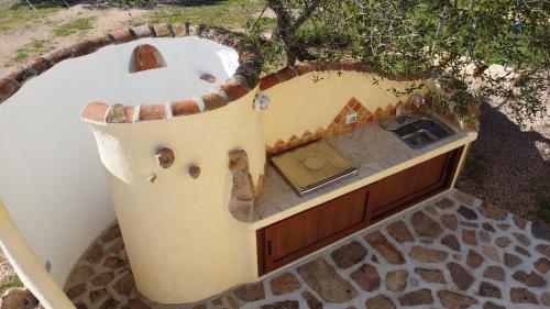 an outdoor bath tub with a sink in a tree at Molti Mari B&B Resort in Olbia
