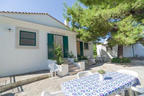 a table and chairs in front of a house at Case Vacanze Uliveto in Mattinata