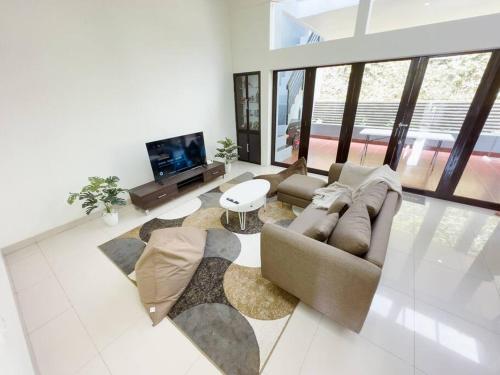 a living room with a couch and a tv at ADORA Home Bandung chill & cozy in Bandung