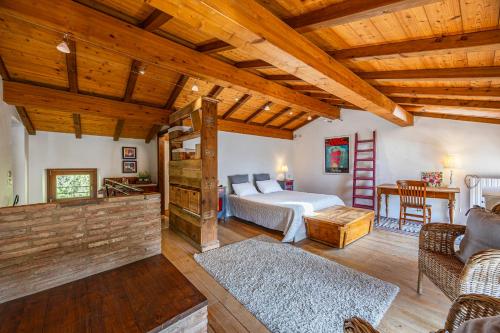 a bedroom with a bed and a living room at Villa Carlotte - quiet and comfort in Pastrengo