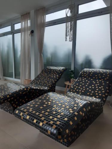 deux lits dans une chambre avec une grande fenêtre dans l'établissement Apartament nr 209 Pastela w Welle, à Grzybowo