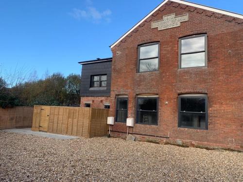 a brick building with windows on the side of it at NEW The Old Drill Hall 4 in Ryde