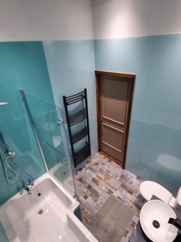 a bathroom with a shower and a toilet and a sink at Apartment 3 The Old Drill Hall in Ryde