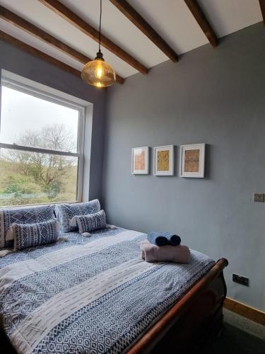 a bedroom with a large bed with a window at Apartment 3 The Old Drill Hall in Ryde