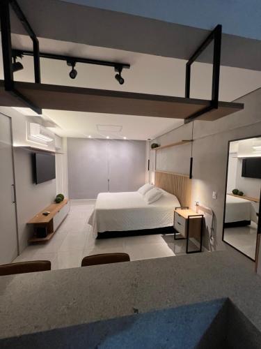 a large bedroom with a bed and a mirror at Apartamento/Studio Novo Hamburgo in Novo Hamburgo