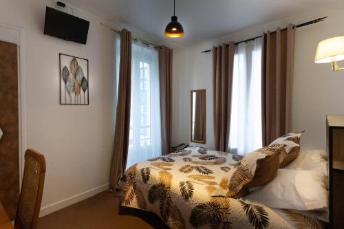 a bedroom with a bed in front of a window at Ideal Hotel in Paris