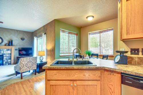 a kitchen with a sink and a living room at Lovely Dundee Home with Private Yard and Fire Pit! in Dundee
