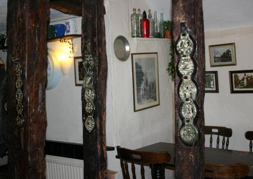 a dining room with a table and a mirror at Farmhouse Inn in Thaxted