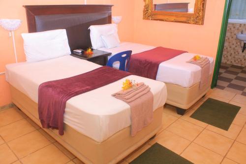 卡薩內的住宿－Luma Guest House，酒店客房,设有两张床和镜子
