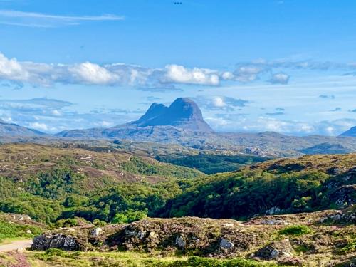 a mountain in the middle of a valley at Stoer Pods - Suilven Pod in Lochinver