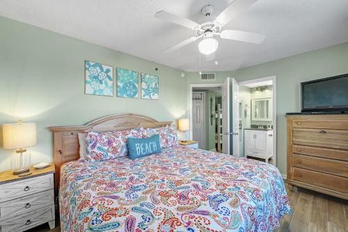 a bedroom with a bed and a ceiling fan at Tradewinds Unit 608 in Orange Beach