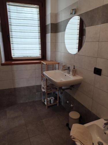 a bathroom with a sink and a mirror at B&B Vivi l'Attimo in Campodenno