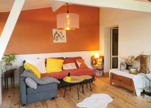 a living room with a couch and a table at la maison du bonheur in Seignosse