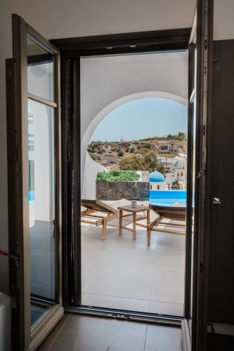 a view from the door of a house with a balcony at Amphitrite Suites Santorini in Vóthon