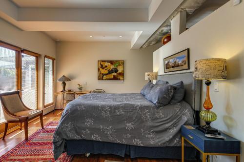 a bedroom with a bed and a table and a lamp at Well-Designed Santa Monica Studio Less Than 1 Mi to Beach in Los Angeles