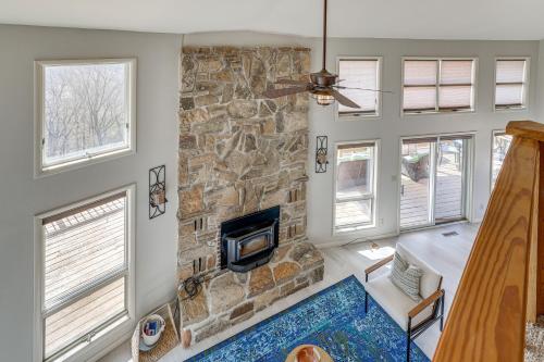 a stone fireplace in a living room with a stone wall at Eureka Springs Gem 2 Decks, Mtn and Lake Views in Golden