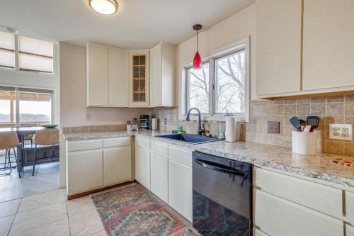 a kitchen with white cabinets and a sink at Eureka Springs Gem 2 Decks, Mtn and Lake Views in Golden