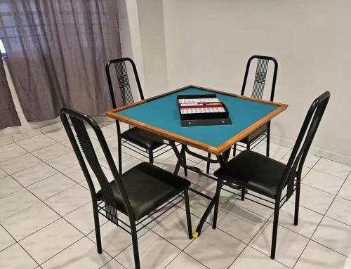 a table with four chairs and a cake on it at Tambun Sunway Homestay in Tambun