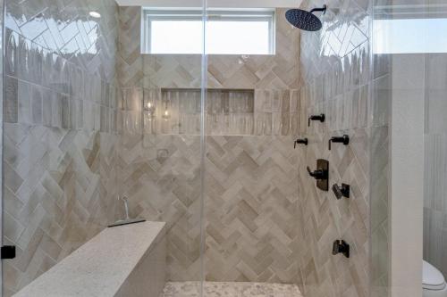 a bathroom with a shower with a glass door at Luxury Beach House Glow in dark golf Game Room in Bolivar Peninsula
