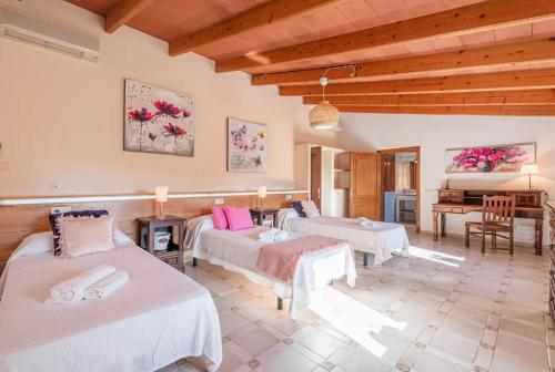 a living room with two beds and a piano at Es Rafal in Santa Margalida