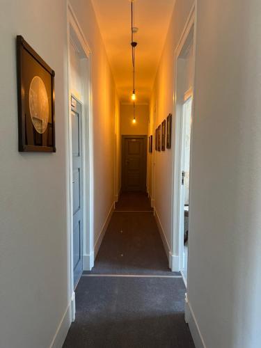 a hallway of a house with yellow walls and a door at Thomar House in Tomar