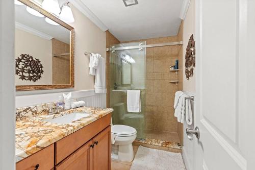a bathroom with a sink and a shower and a toilet at Waterfront Pools and Cabana by Duck Keys Marathon in Marathon