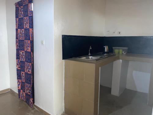 a kitchen with a sink in a room at Chambre en bord de mer …(pied dans l’eau) in Ngalou Sessène