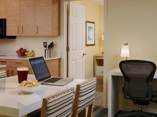 a kitchen with a table with a laptop computer on it at Avia Residences on Lincoln - Extended Stay in Malvern