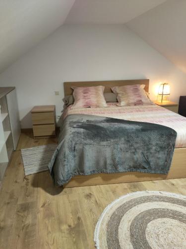a bedroom with a large bed and a rug at Tresor de Beaurains in Beaurains