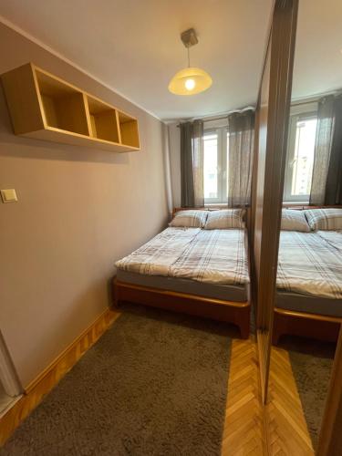a small room with two beds in it at Apartament 11 Stogi in Gdańsk