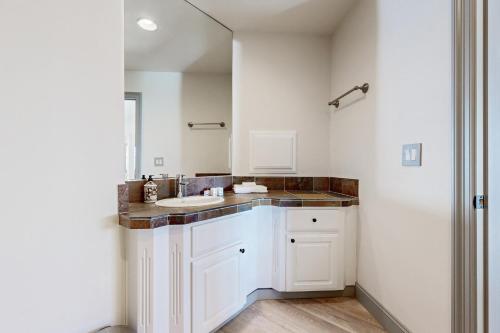 a white bathroom with a sink and a shower at Hillside Sanctuary in Portland
