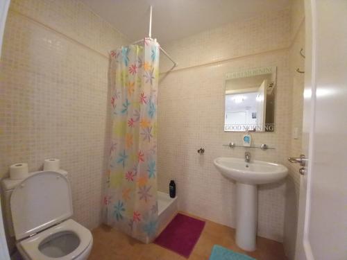 a bathroom with a toilet and a sink at Balcon de Altea hills in Altea
