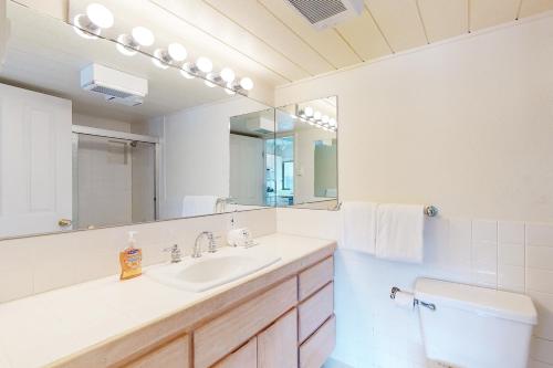a bathroom with a sink and a toilet and a mirror at Creekside 1274 in Sun Valley