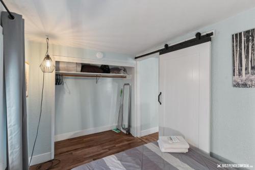 a room with a closet with a sliding door at Borealis Barnhouse - Slumber 7 in Anchorage